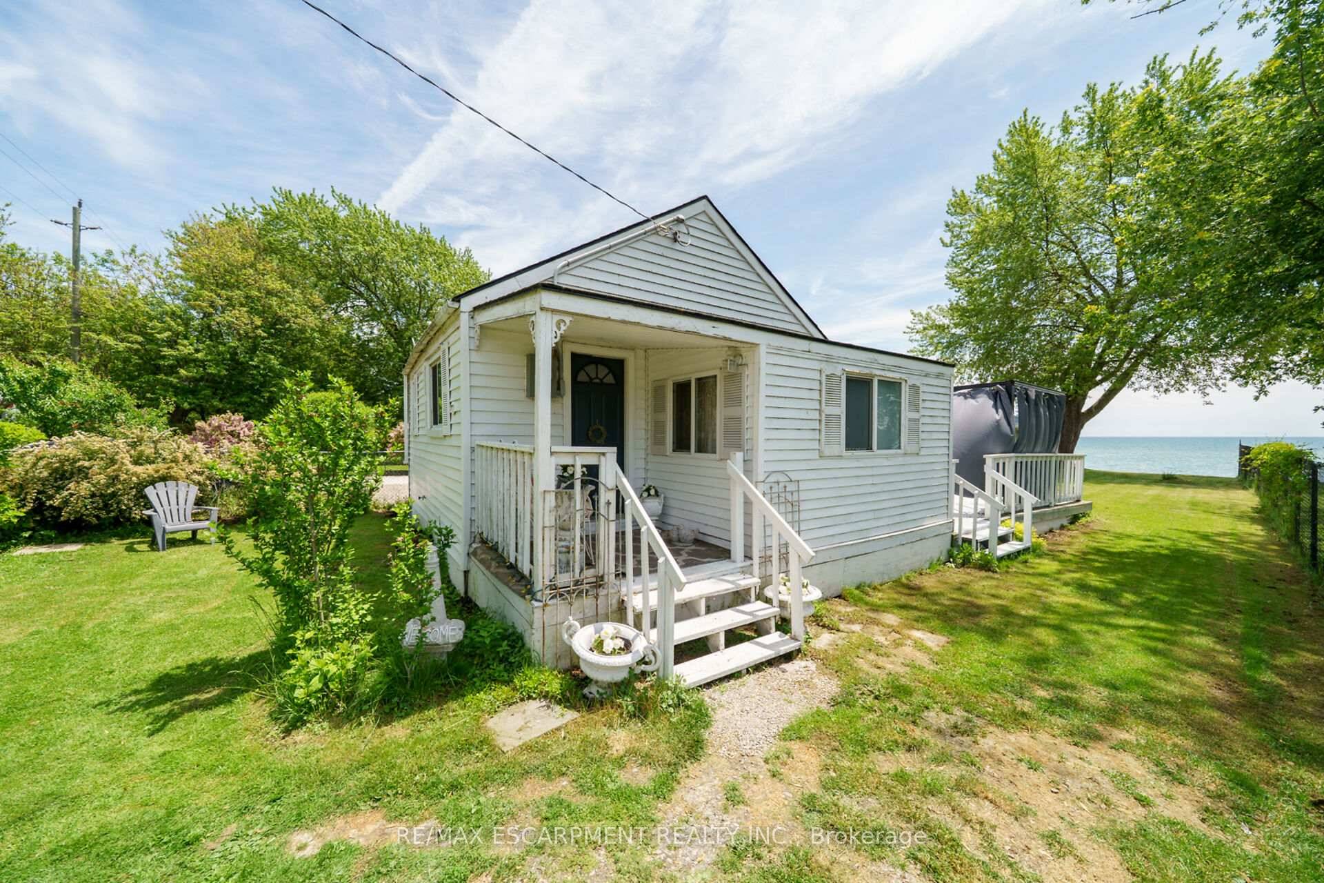 Dollhouse on the Lake ! Lovely two bedroom, one bath home on nice waterfront lot, dotted with mature trees and blossoming spring foliage needs a new owner !