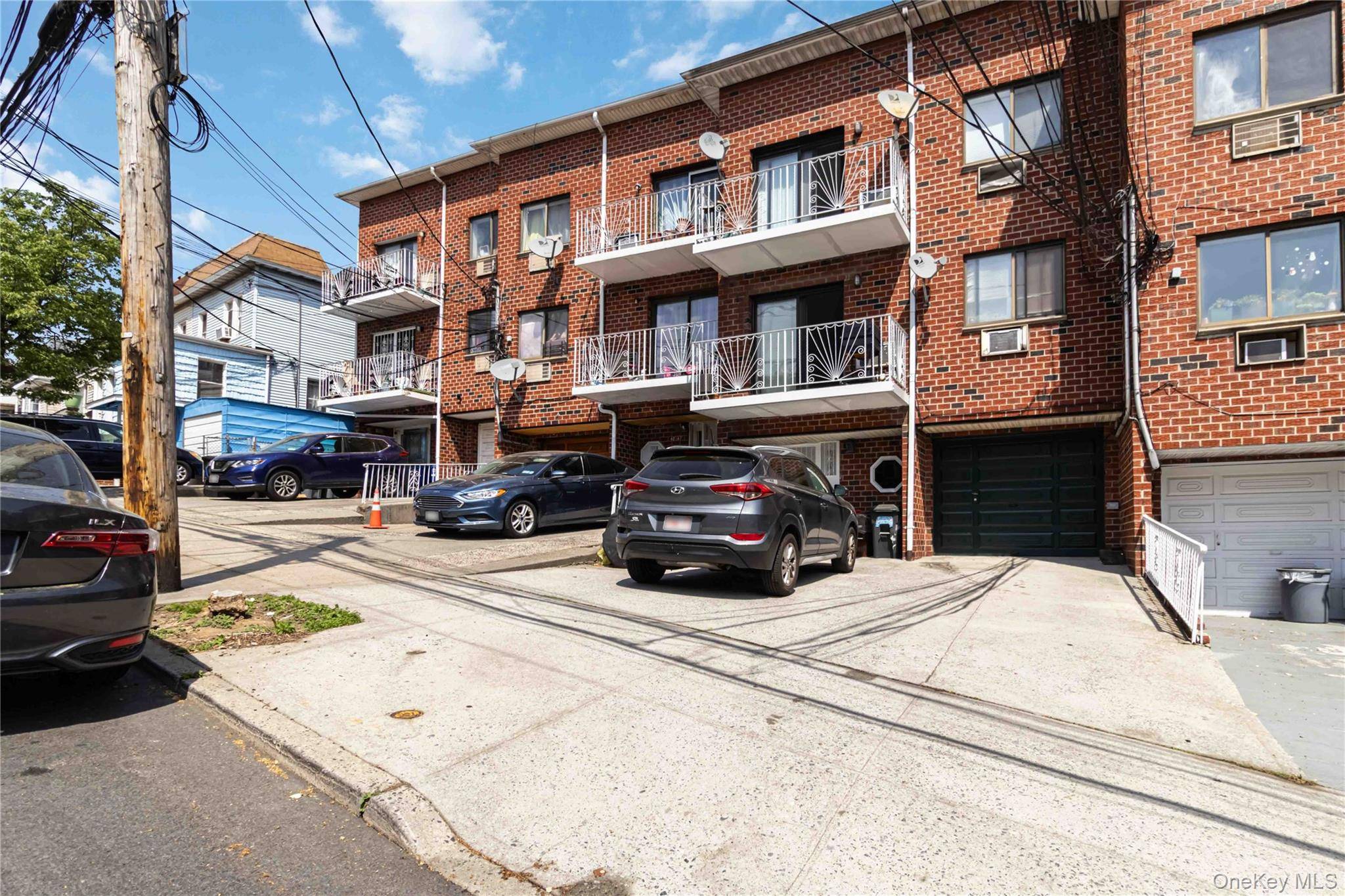 Solid brick 4 family built in 1985 featuring spacious units with hardwood floors, granite countertops, updated cabinets, and private balconies in every apartment.