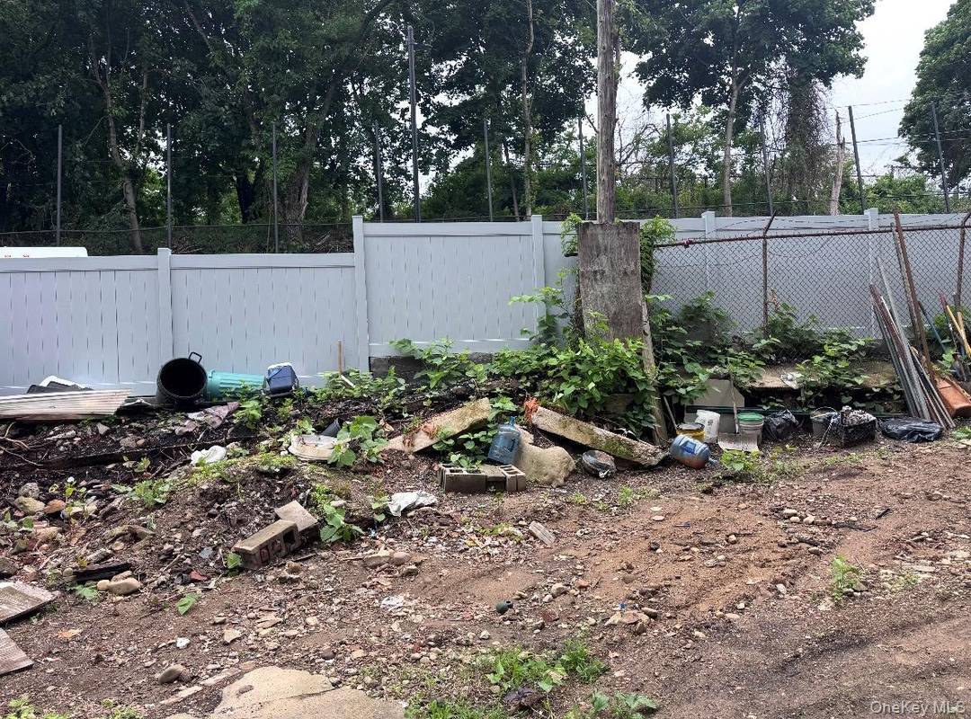 The lot features an impressive 60 foot frontage with an existing full length curb cut, ideal for private driveway access, parking, or storage in its current condition.