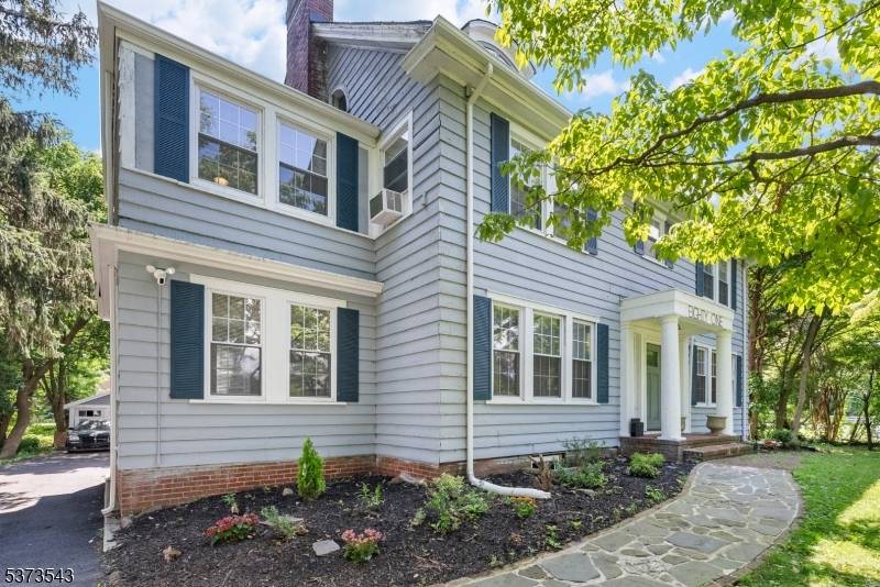 Welcome to this stately Colonial home with modern charm nestled on a spacious, tree lined lot.