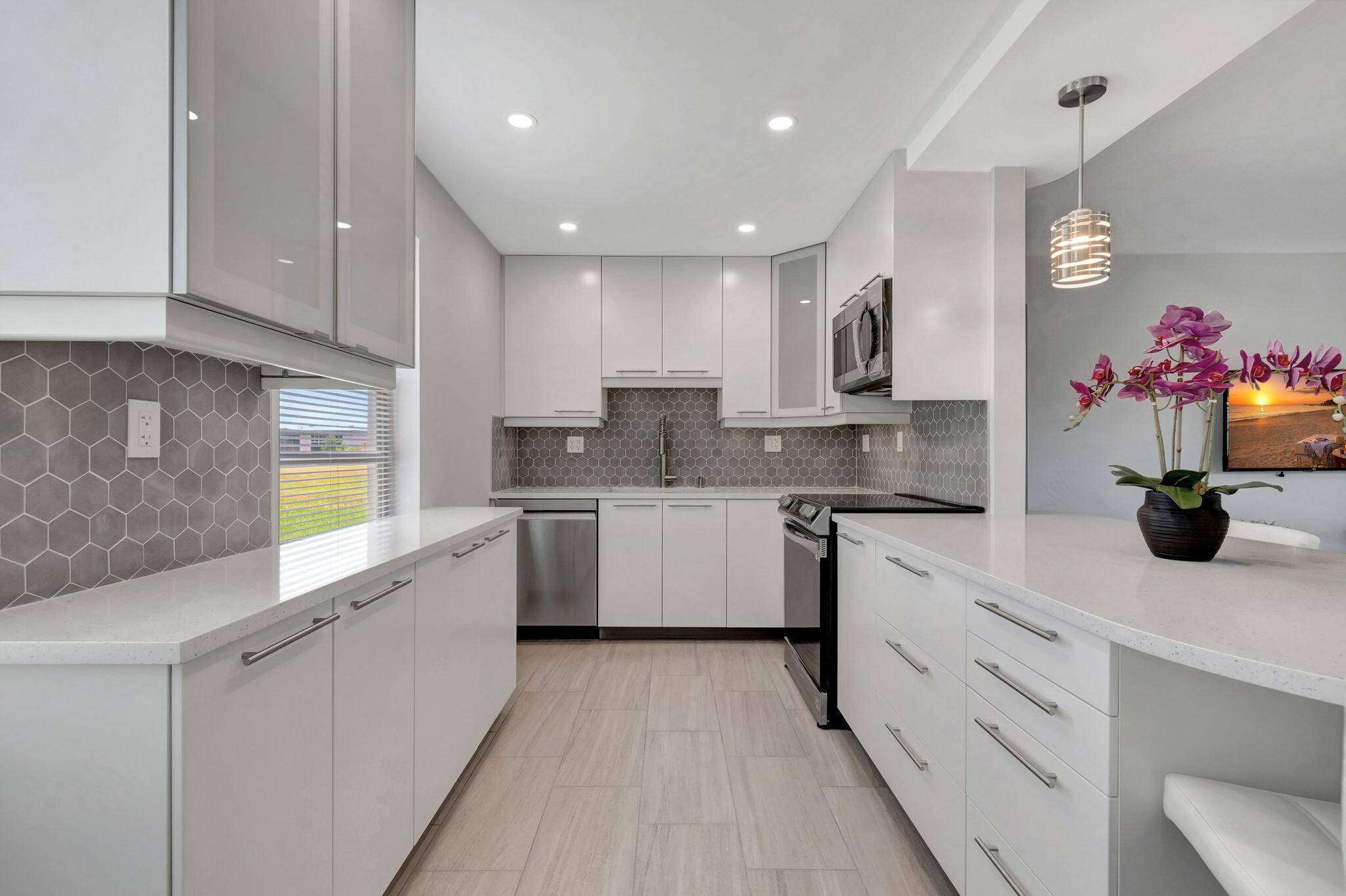Welcome to 164 Normandy Lane, a stunning corner unit situated on the ground floor of a serene golf course community in Delray Beach, FL.