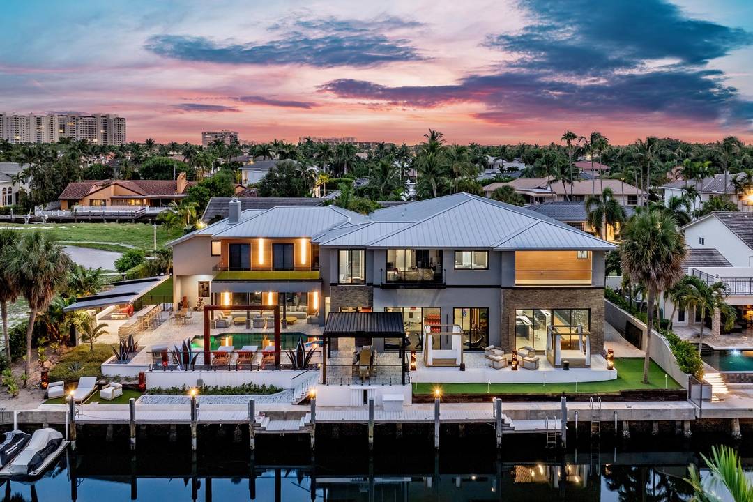 Discover 839 NE Bay Isle Drive, a newly built contemporary masterpiece in Boca Bay Colony.