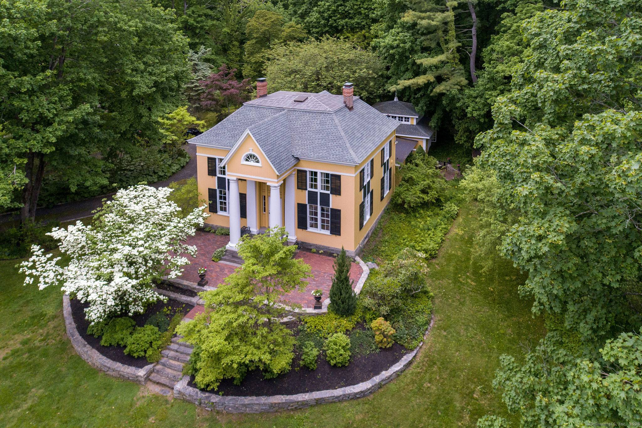 Once known as Hartsbourne, this storied Madison residence is celebrated for its premier location overlooking the town green and its timeless architectural presence.
