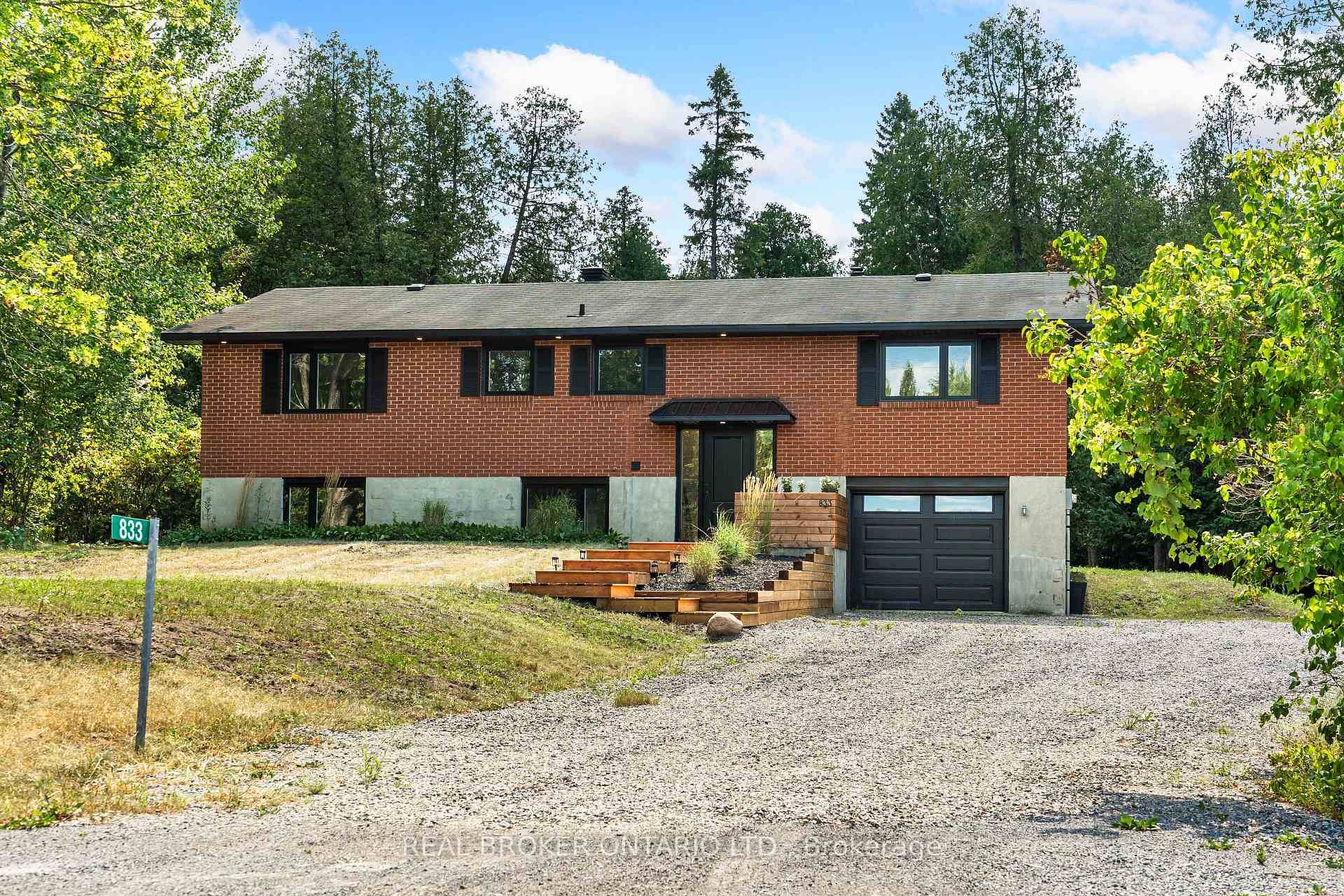 Welcome to this updated 5 bedroom split level brick home, tucked away on a private, treed 2.