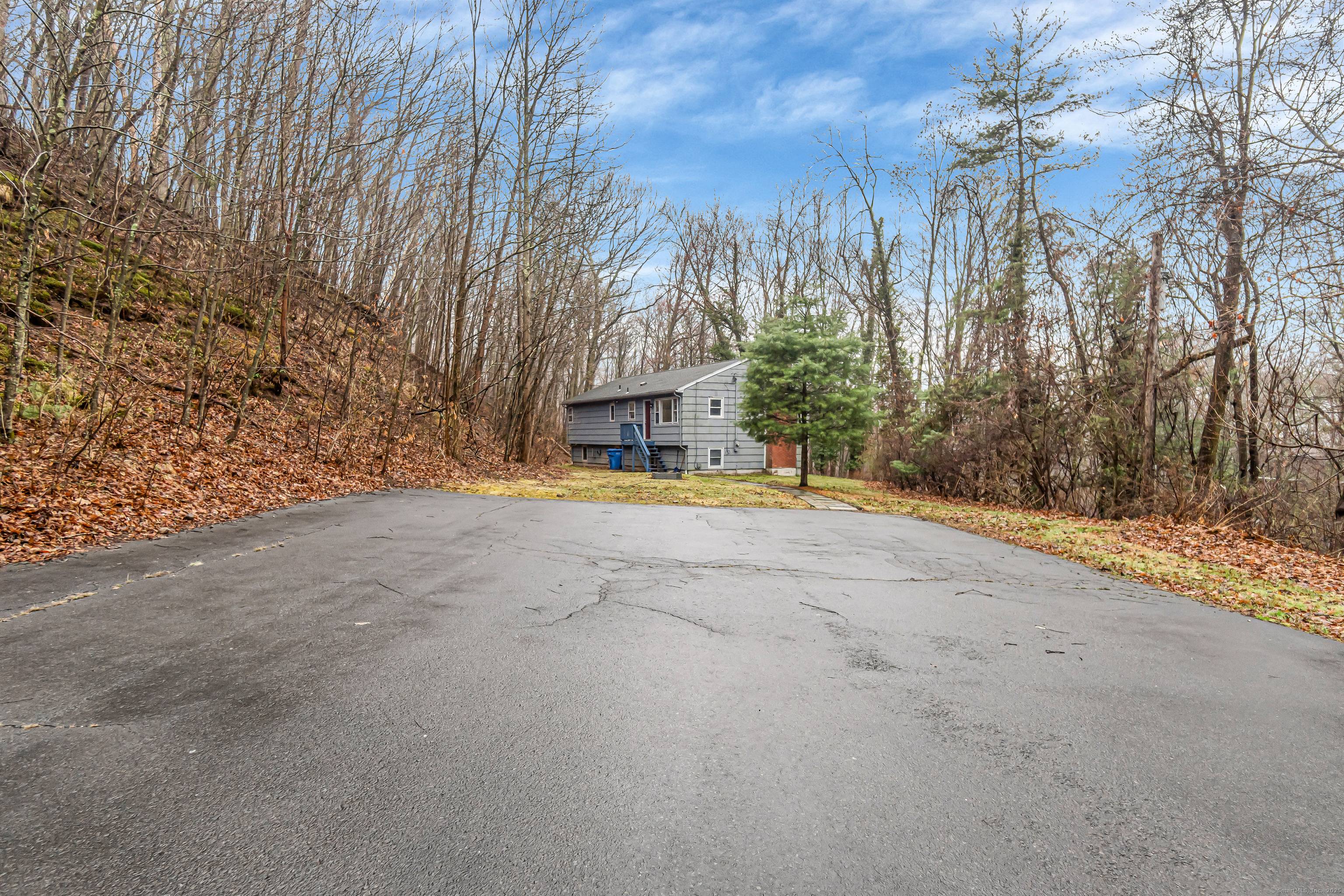 Tucked away on a private lot with a long, winding driveway, this charming single family home invites you into a peaceful, wooded retreat.