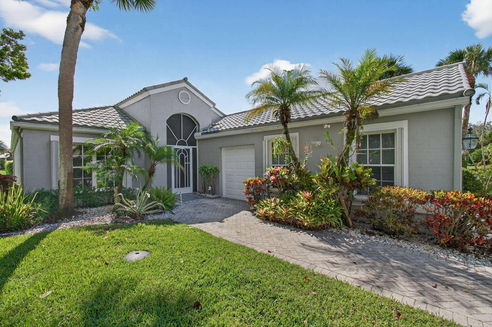 This elegant three bedroom, three bath home is situated on a corner lot and offers picturesque views of both water and the golf course.