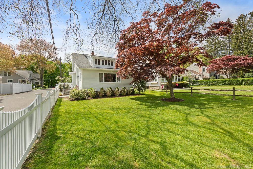 Sun filled, Beachy Colonial ideally located beside a coveted private cul de sac just moments from the Darien train Darien Commons.