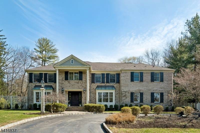This elegant 6 bedroom Brick Front Colonial is ideally located on.