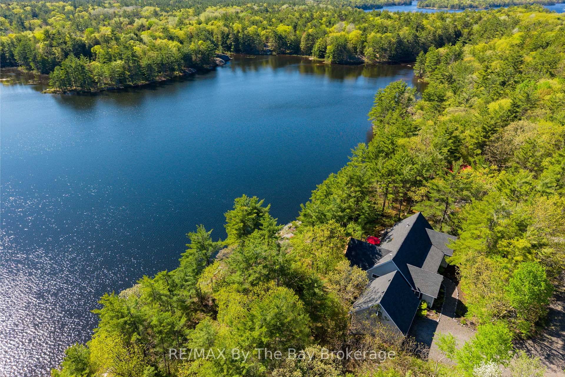 Only ten minutes west of Hwy 400 Exit 168, this extraordinary 46 acre property offers the ultimate in privacy, natural beauty, and refined lakeside living.