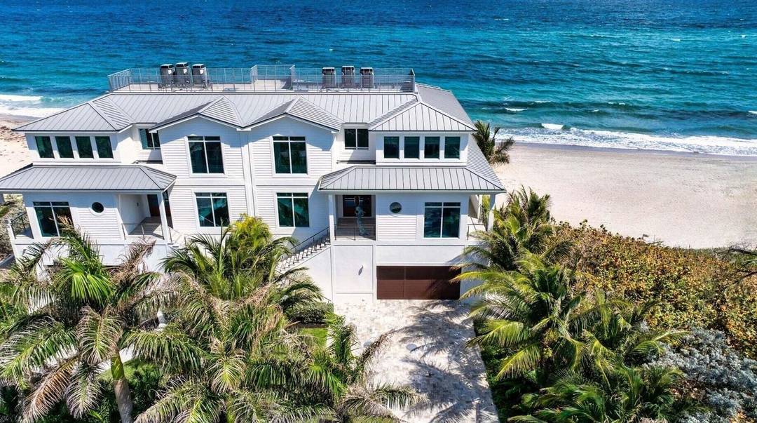 Ocean Ridge townhome, perched directly on the sand, showcases a sunny deck and an expansive wraparound balcony perfect for catching the sunrise.