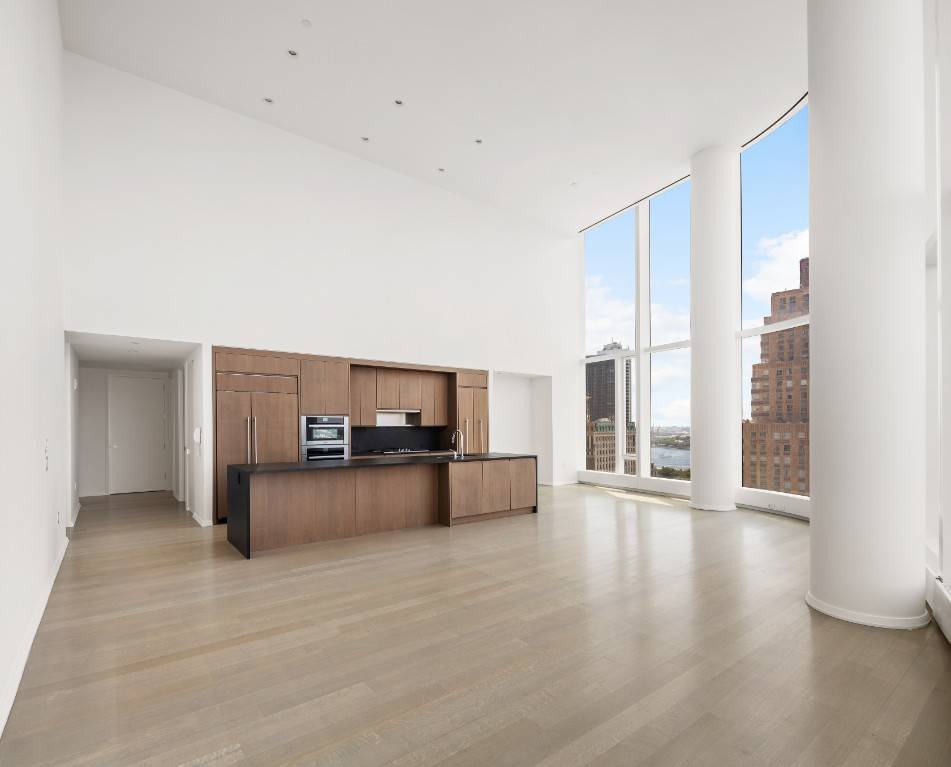 Just across from Battery Park Enjoy stunning southwestern Hudson River views through a complete wall of double height windows, from the 22nd floor of the luxurious 50 West condominium.
