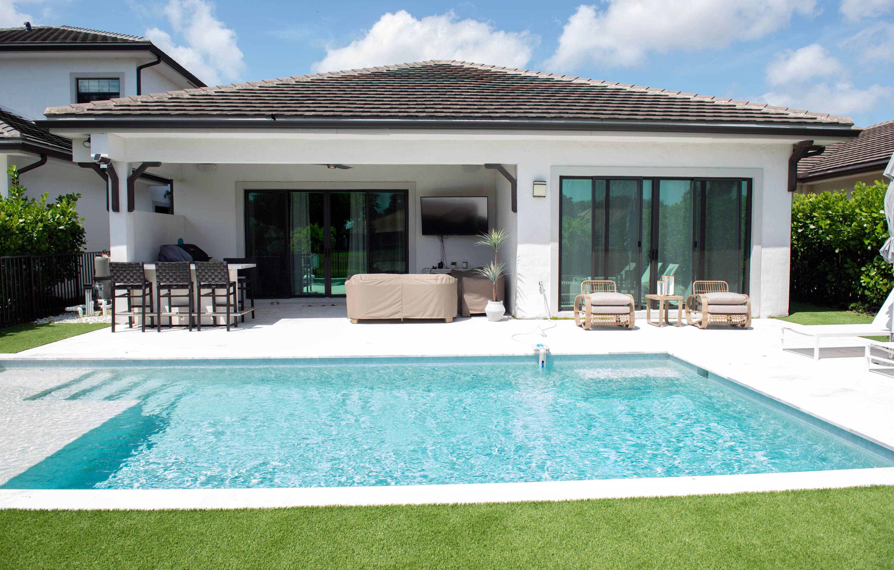 Welcome to this stunning, fully furnished contemporary single family home nestled within the exclusive Banyan Cay Resort Club.