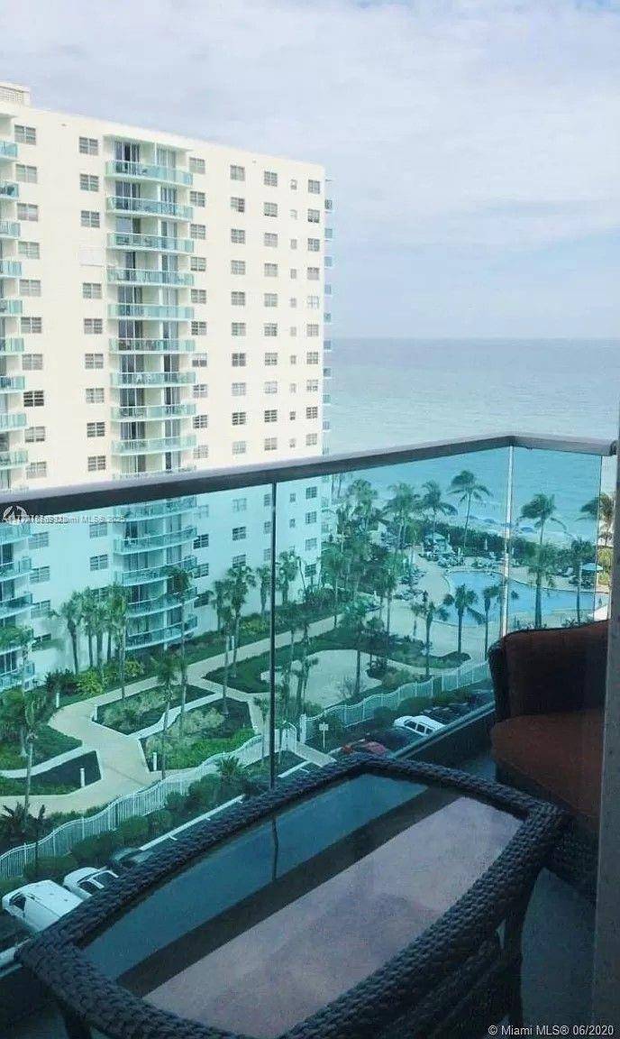 Stunning oceanfront apartment with breathtaking views, featuring a fully furnished one bedroom unit and an open balcony.