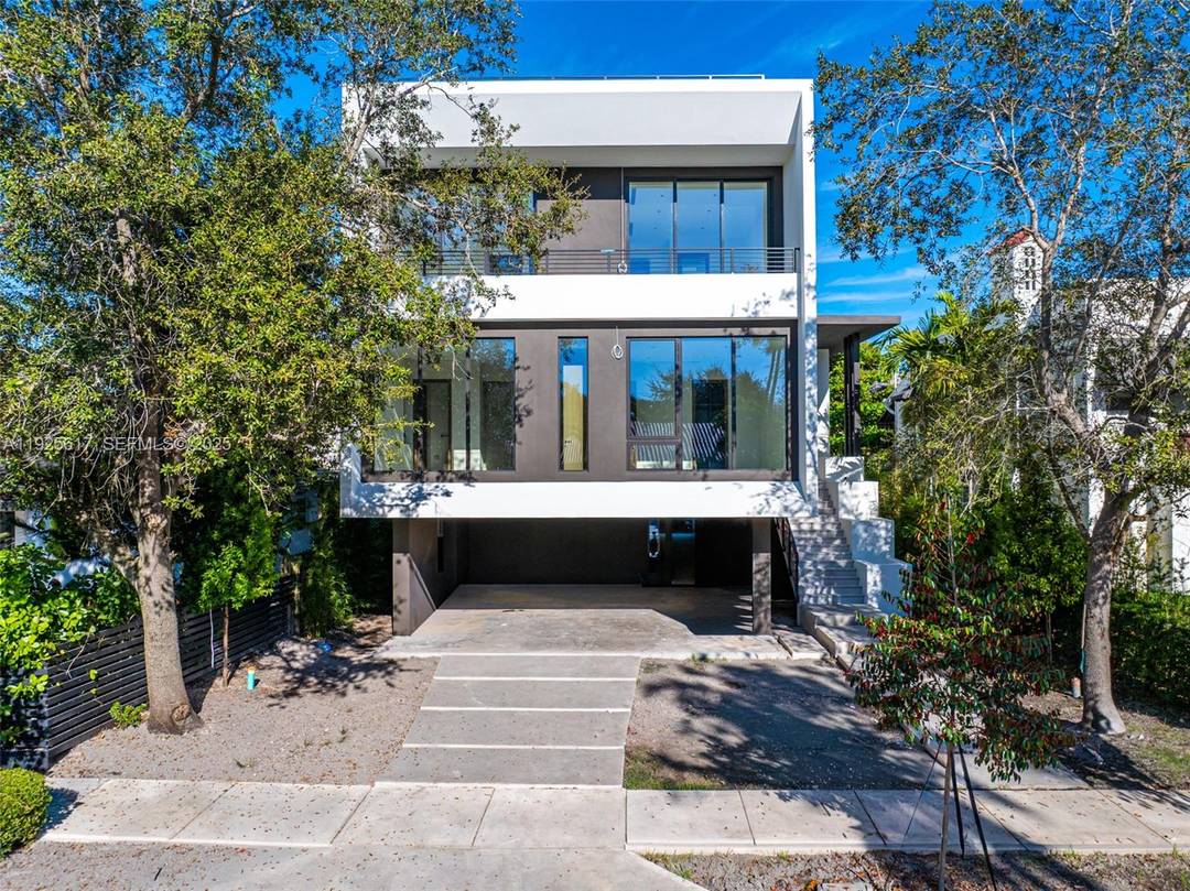 Experience refined luxury in this exceptional Coconut Grove residence, where open concept interiors, bespoke built ins, and sophisticated finishes create an atmosphere of elevated living.