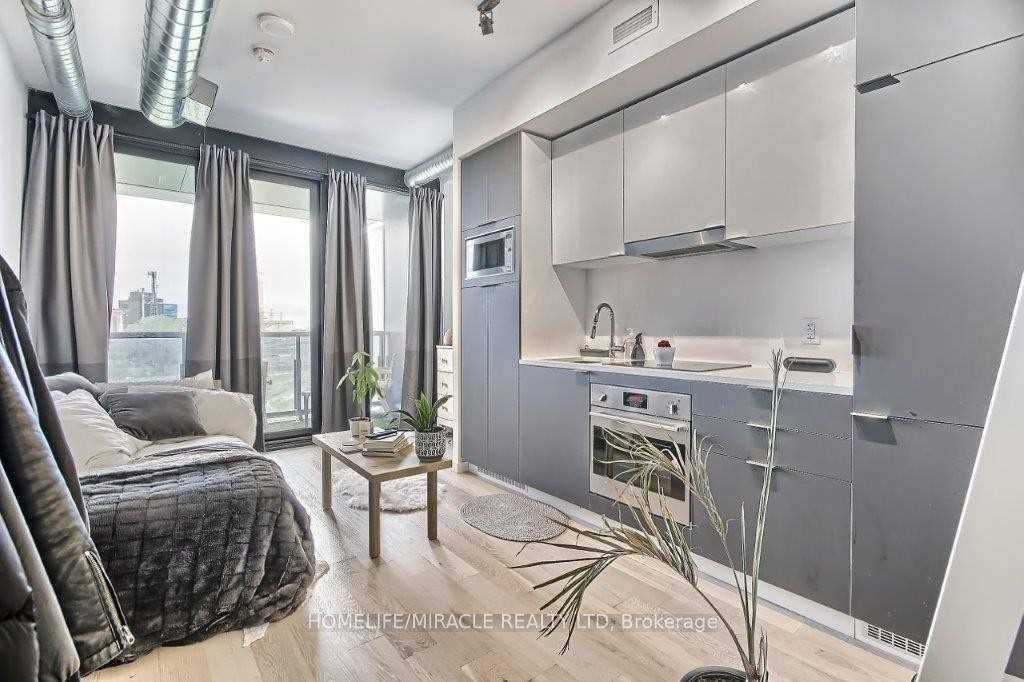Bright and efficiently designed bachelor suite with a private, unobstructed view overlooking Corktown Park, just steps from the Distillery District.