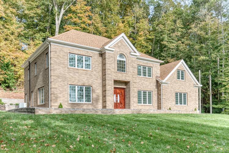 STUNNING BRICK HOME NESTLED IN A SECLUDED MOUNTAINSIDE SETTING !