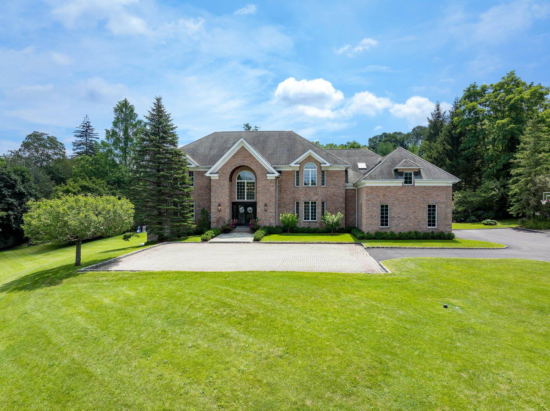 Nestled behind a gated entry on nearly three private acres in Armonk, this stately brick colonial offers a world of refined luxury and total seclusion.