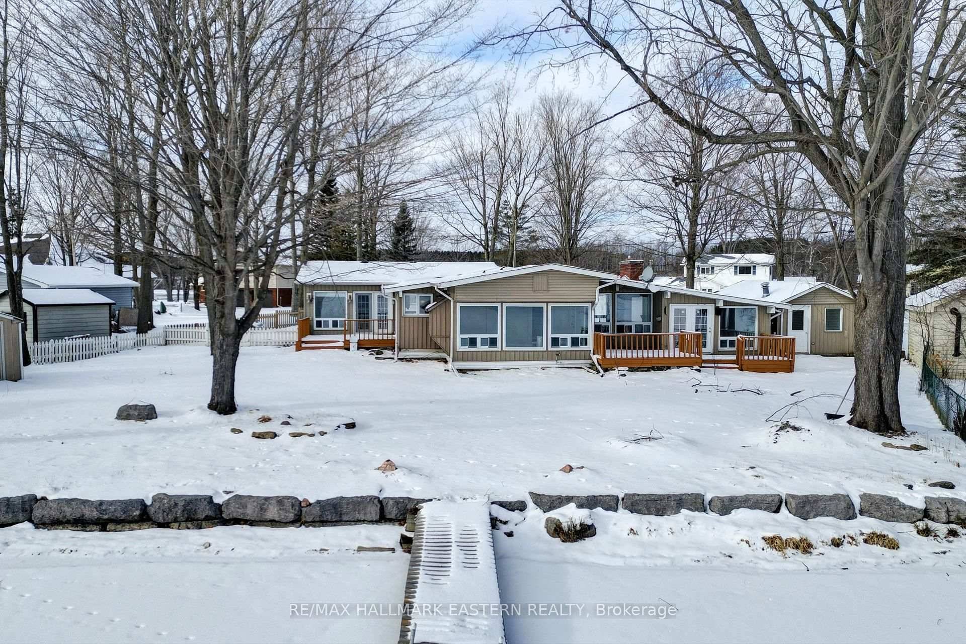 WATERFRONT GEM IN THE HEART OF IT ALL Discover the epitome of lakeside living with this waterfront gem offering 1, 926 square feet of main floor living on virtually one ...