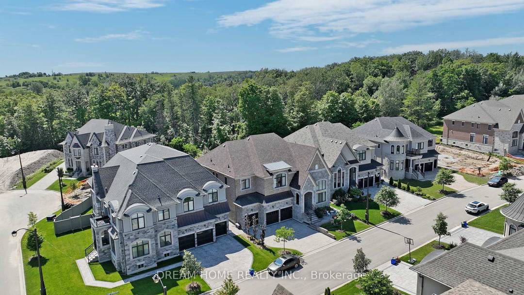 Nestled on a premiem Ravine view lot within the distinguished Upper Thornhill Estates, this refined residence in a gated ENCLAVE captivates with its seamless open concept design.