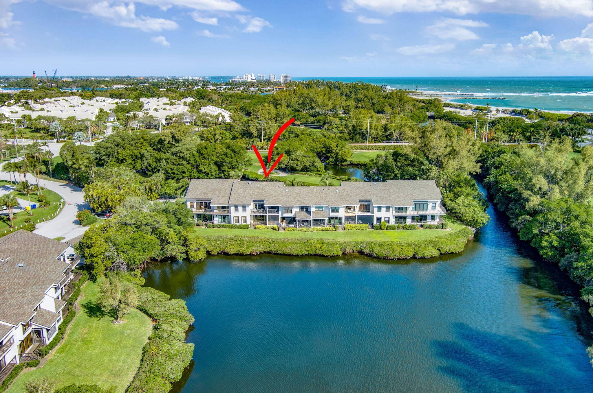 Absolutely amazing long water views of Jupiter's natural estuary from this beautifully renovated 2nd floor residence in the golf beachside community of Jupiter Dunes.