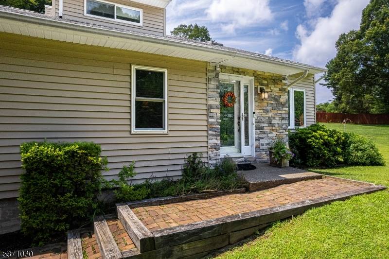 Welcome to this beautifully updated Contemporary Colonial tucked privately off highway on 1.