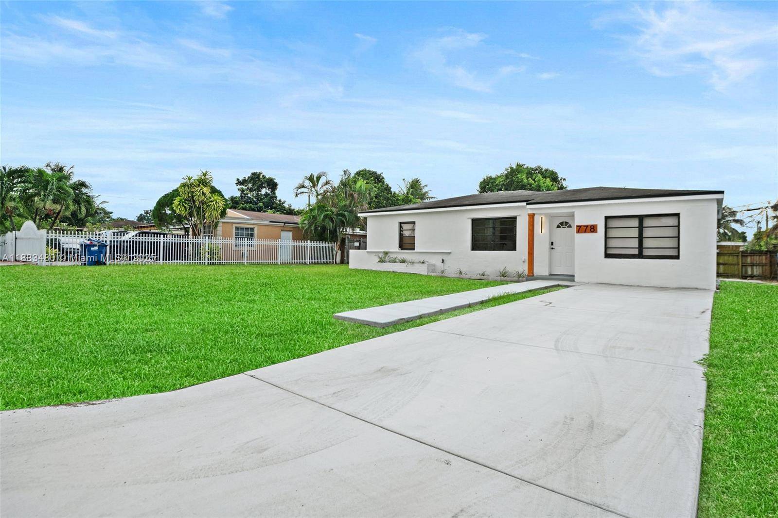 Beautiful 3 bedroom, 2 bathroom single family home in Biscayne Gardens featuring updated vinyl flooring throughout and a modern kitchen with center island, ideal for gatherings.