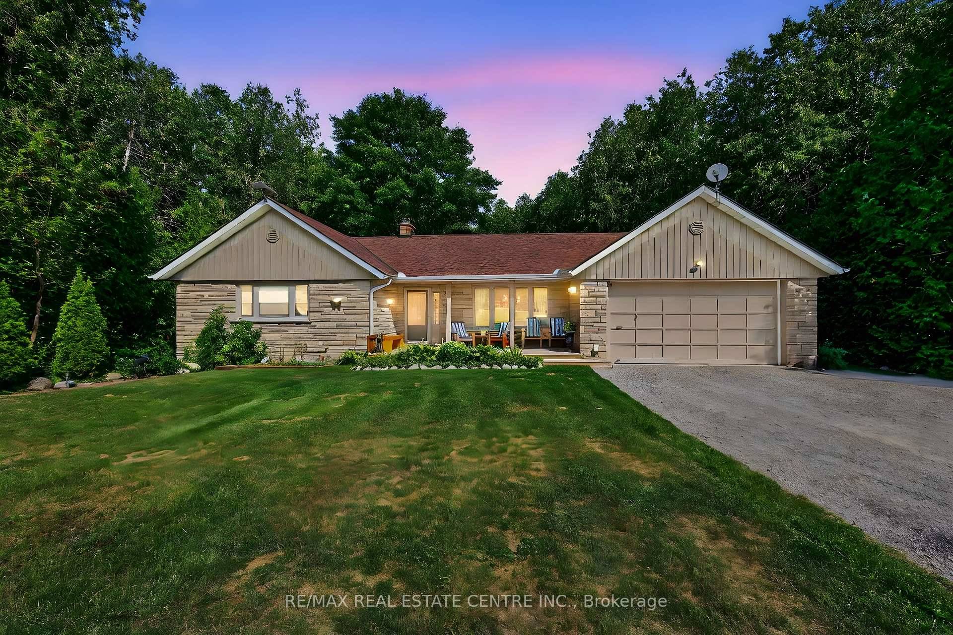 Discover this stunning bungalow nestled on a quiet dead end country road, set on a breathtaking 1.