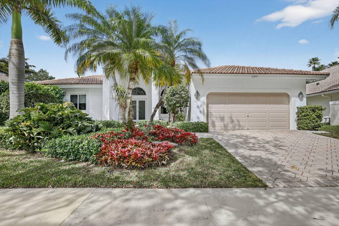 Totally updated kitchen and bathrooms in this four bedroom, 3 bath home with pool overlooking water and golf course in Grand Oaks in upscale Weston Hills.