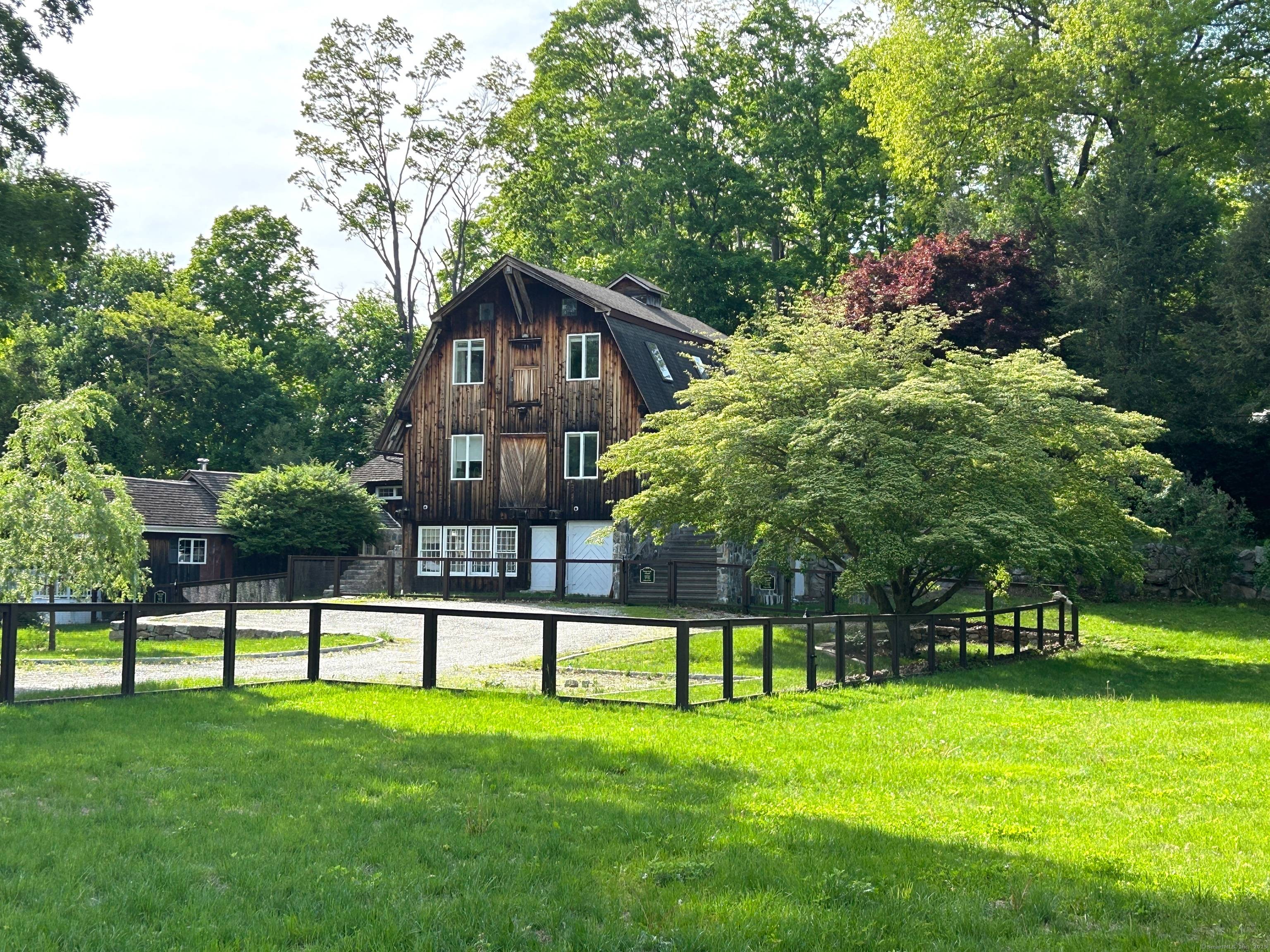 This extraordinary property stands as a testament to thoughtful preservation and modern comfort with soaring 11 foot ceilings and walls of glass that flood the interior with natural light.