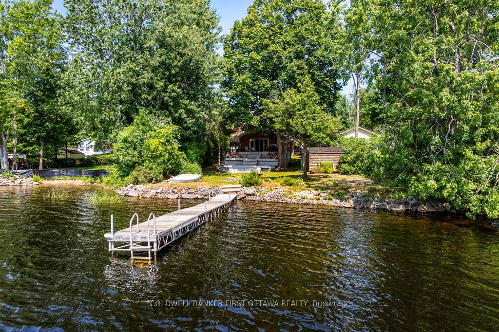 Lakefront bungalow retreat with garage workshop and carport, on picturesque Mississippi Lake.