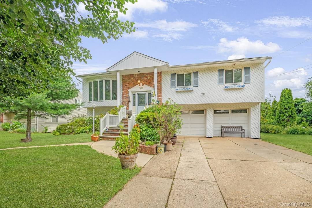 Welcome to 52 North Drive, a beautifully gut renovated split level home nestled on a quiet, tree lined street in the highly sought after Herricks School District.