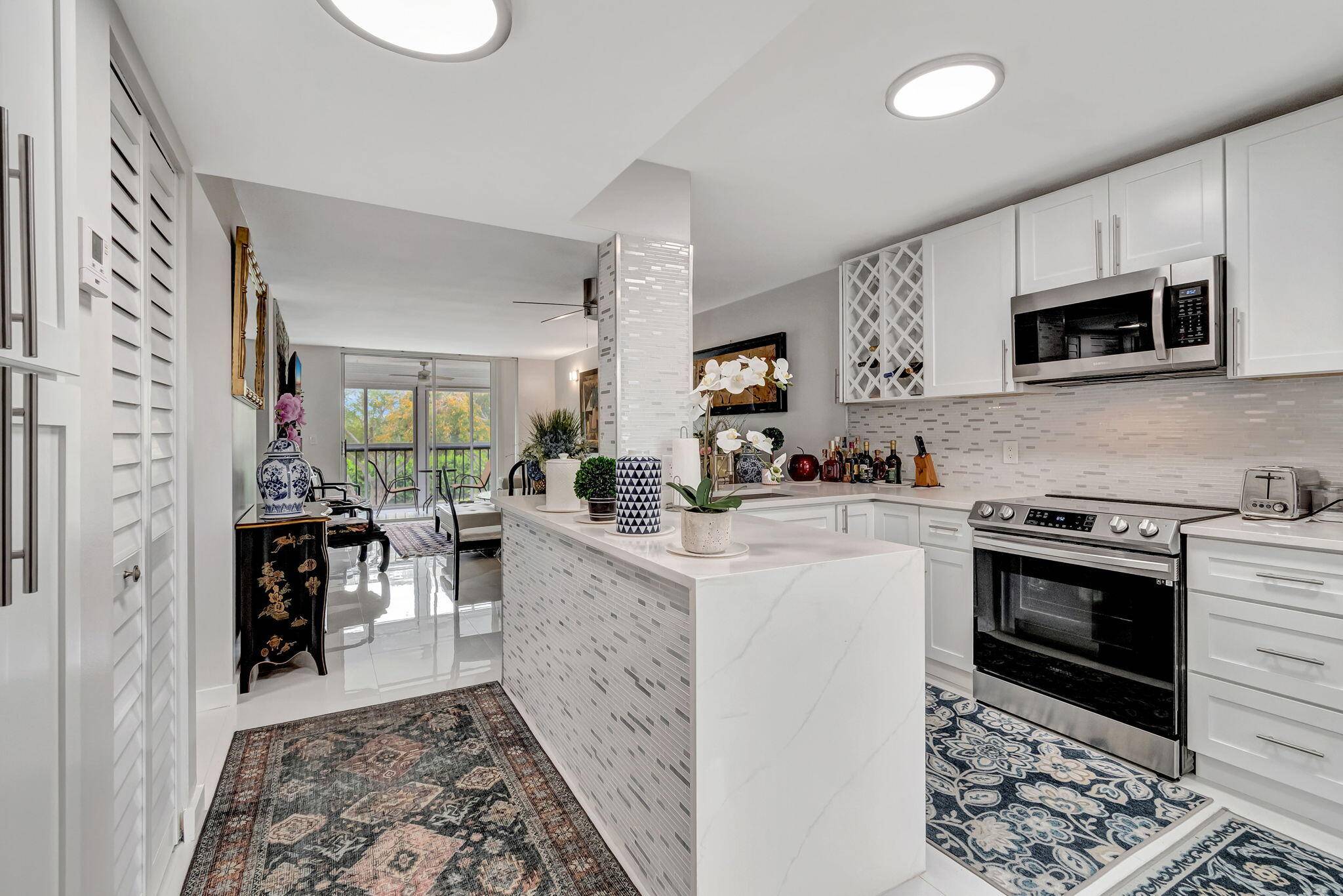 Discover this beautifully renovated condominium, bathed in natural light and situated in the highly sought after 55 community of Huntington Lakes.