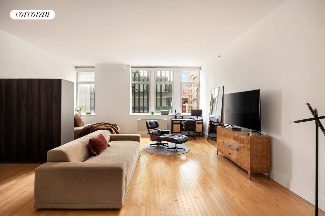 Residence 5B at the iconic 25 SoHo is a sun filled 838 square foot loft defined by soaring 11 foot ceilings and dramatic oversized windows overlooking West Houston Street.