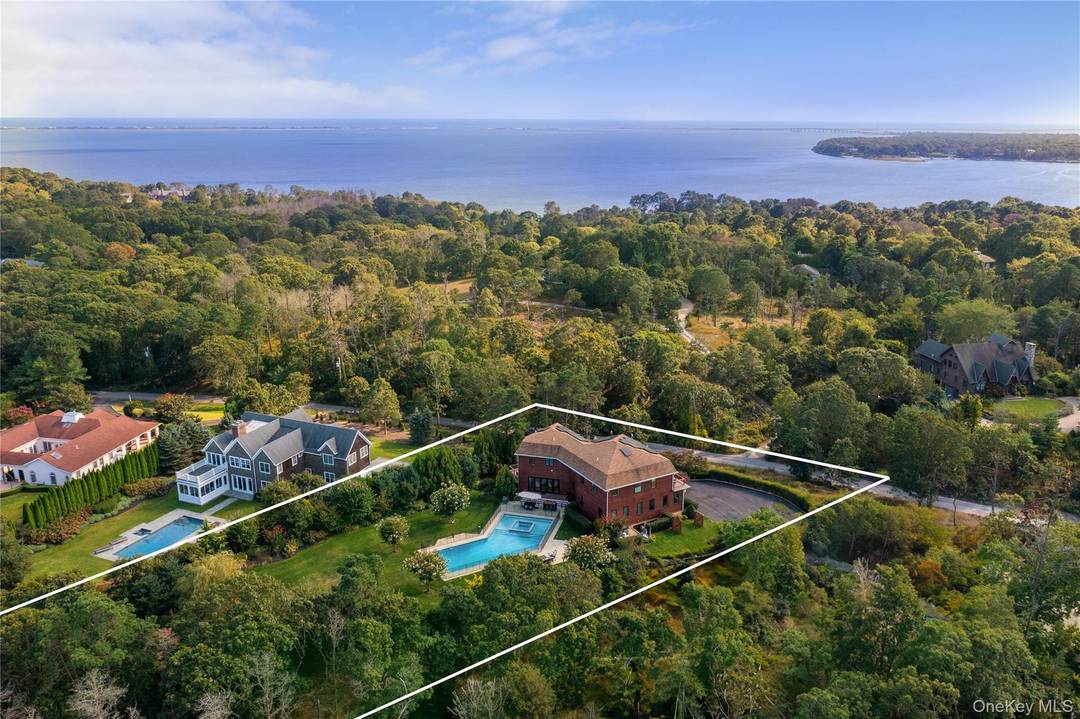 Tucked away on a lush, one acre lot in Shinnecock Hills, this exquisite 6 bedroom, 7.