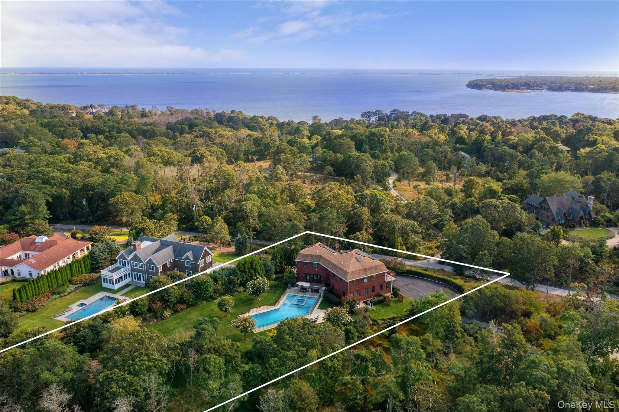 Tucked away on a lush, one acre lot in Shinnecock Hills, this exquisite 6 bedroom, 7.