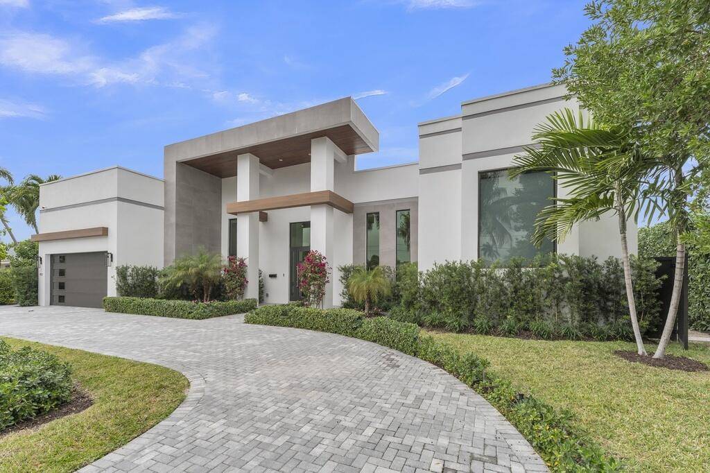 Modern waterfront living awaits in this 2023 built custom residence by Gold Coast Homes, now offered as a resale in the desirable Tropic Isle neighborhood of Delray Beach.