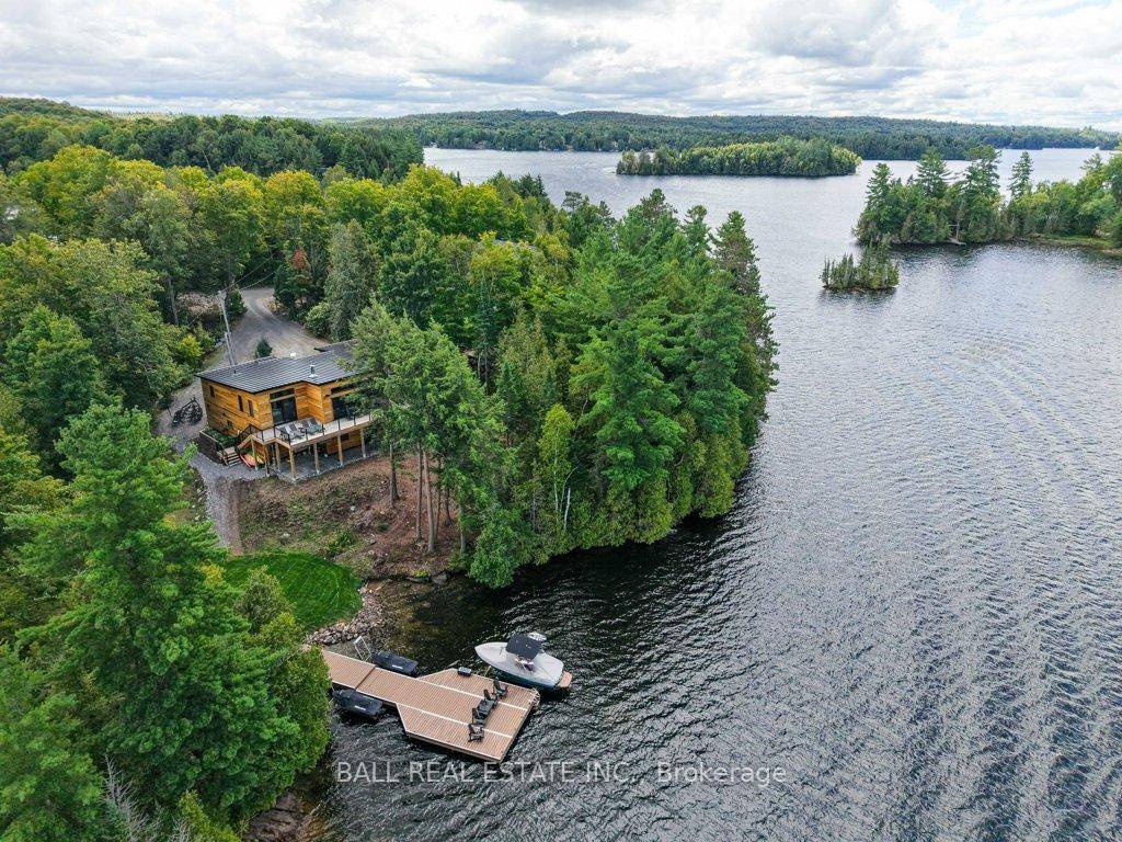 LUXURY LAKEHOUSE One of the most prestigious point lots on Paudash Lake, this stunning 2022 custom built bungalow is tucked in the trees at the end of a year round ...