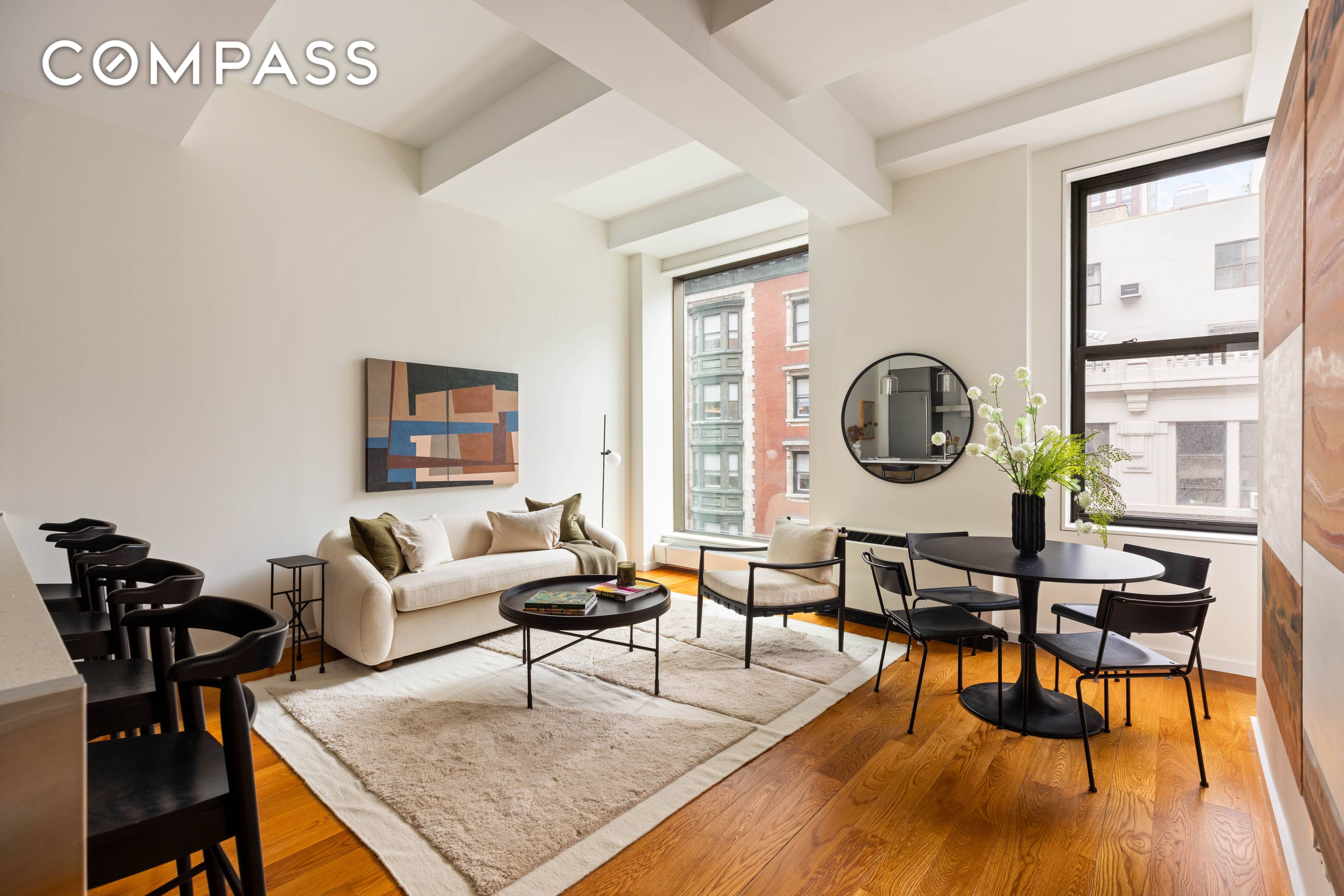 76 Madison Avenue, Unit 8C is a spacious 1 bedroom, 1 bath condominium in NoMad, featuring 11 high beamed ceilings and oversized windows offering skyline views.