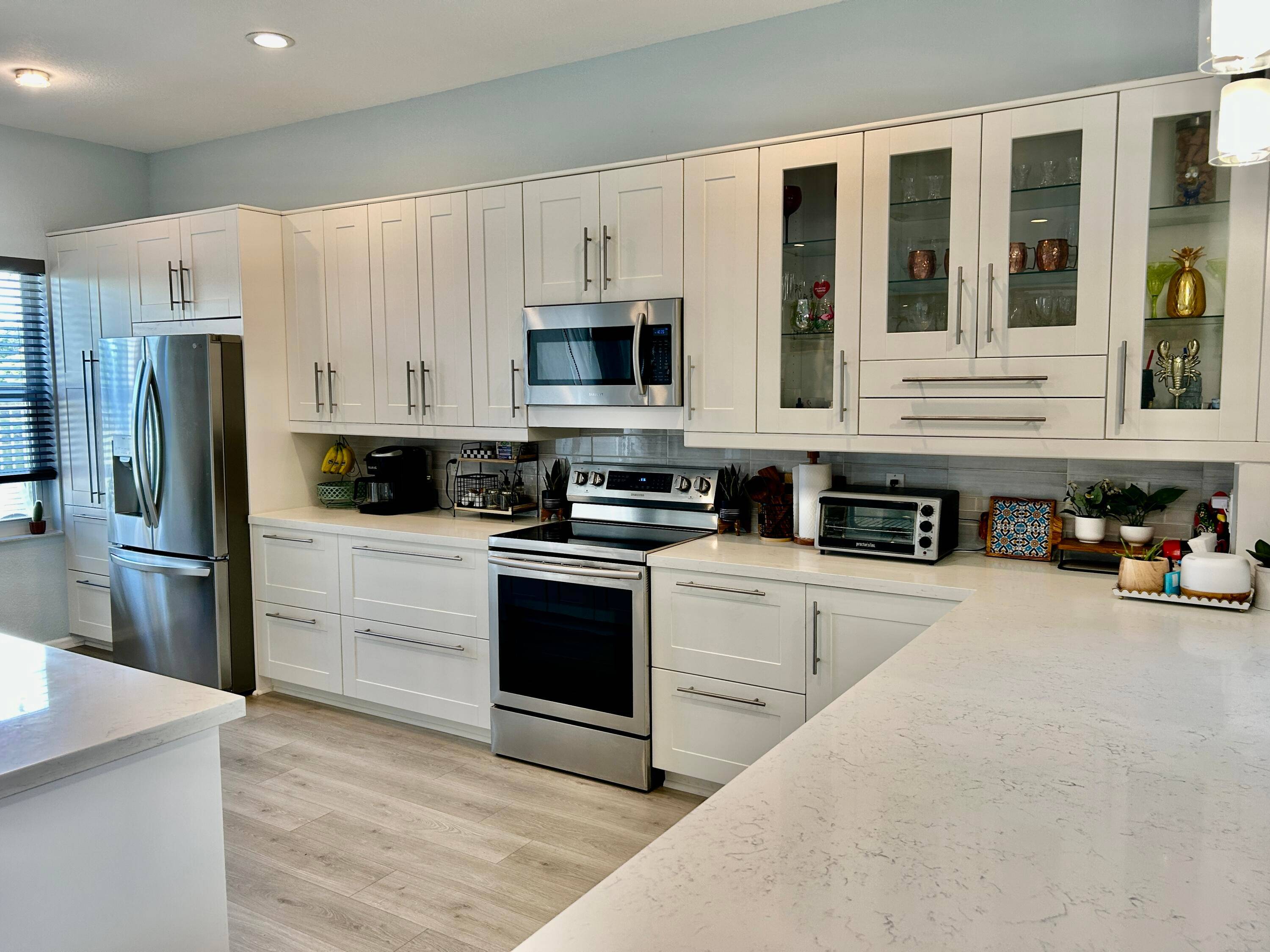 Stunning light and bright modern renovated home on a cul de sac with gorgeous lake views, a private heated pool, fenced in yard, and impact windows in a much sought ...