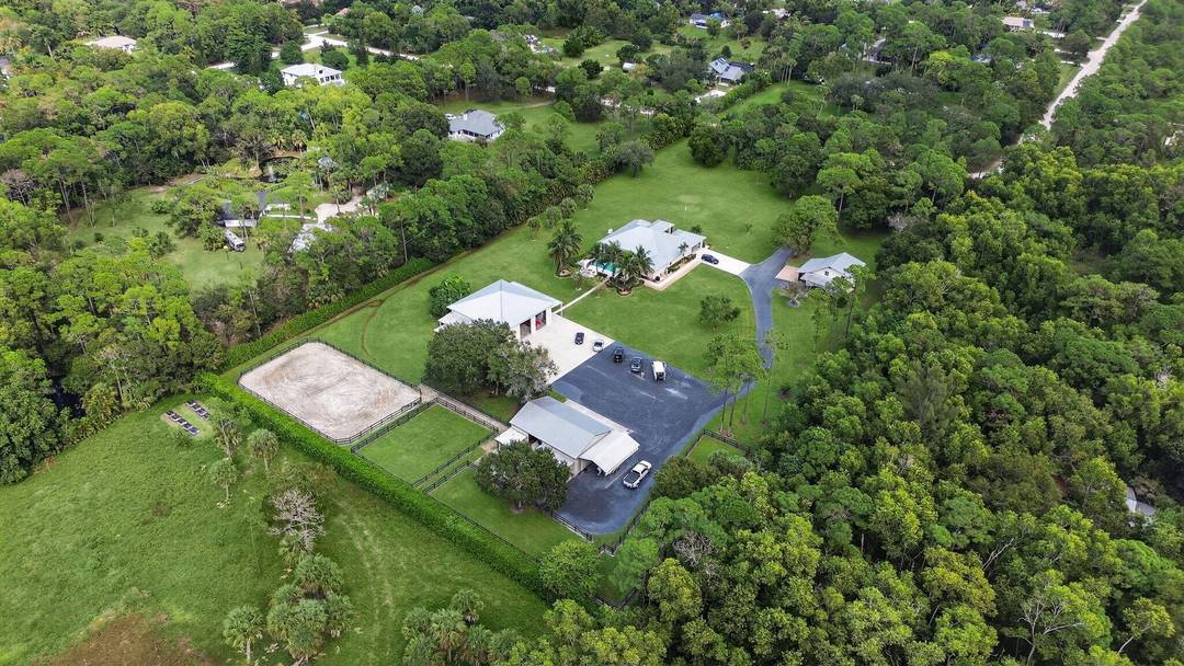 Welcome to a rare estate of distinction in the heart of Jupiter Farms 17593 Winterhawk Trail, a 5.