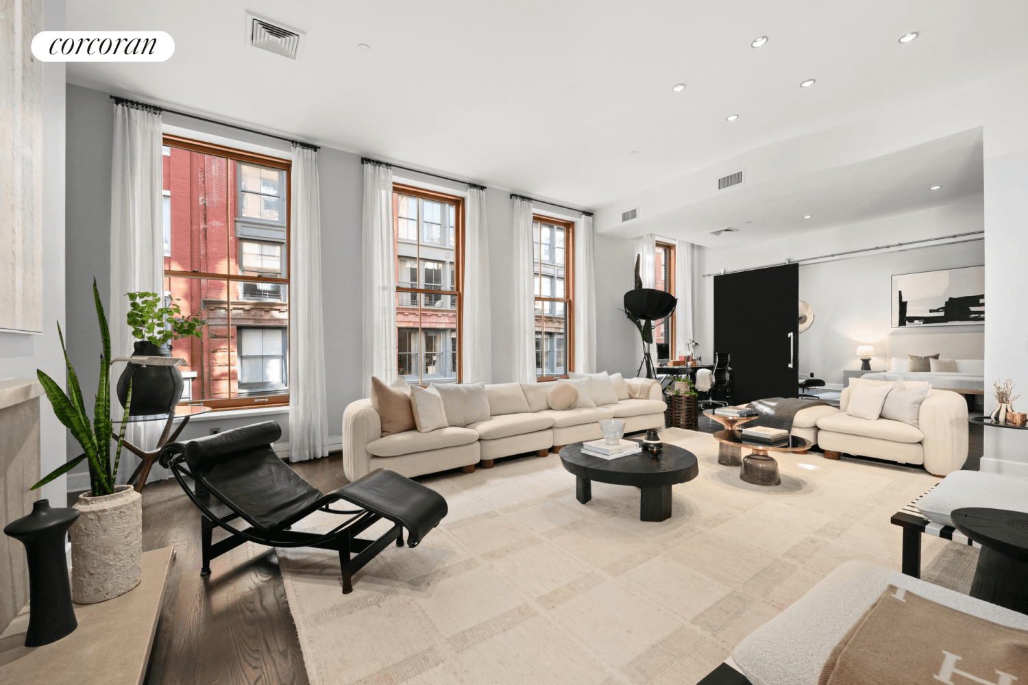 Quintessential SoHo loft living awaits in this stunning oversized one bedroom, two bathroom, plus home office, residence featuring grand proportions and sophisticated interiors in a beautifully renovated historic elevator building.