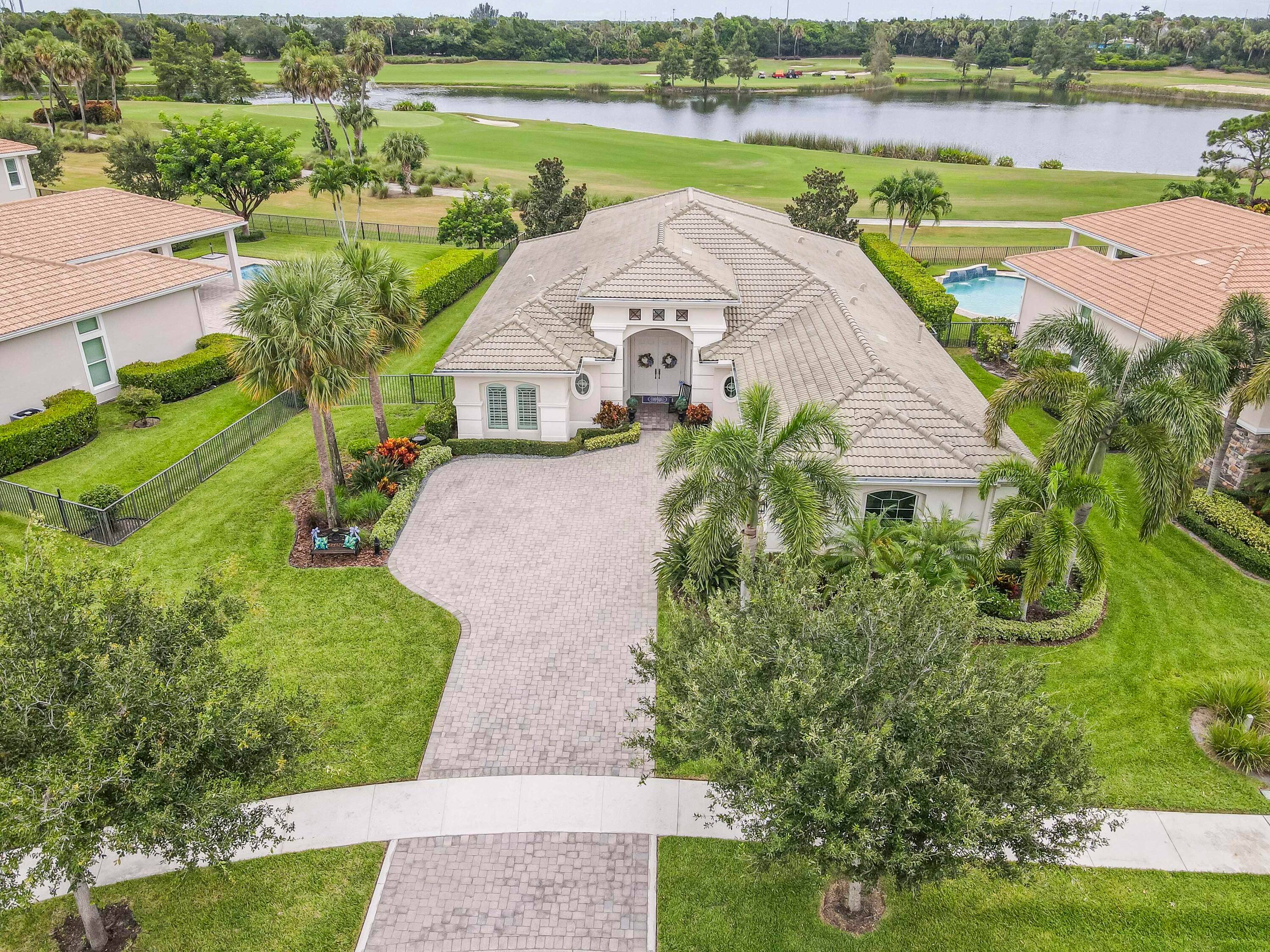 Live luxuriously comfortably in this single level Beaumont model with an ultra private homesite in the resort style gated community of Jupiter Country Club.