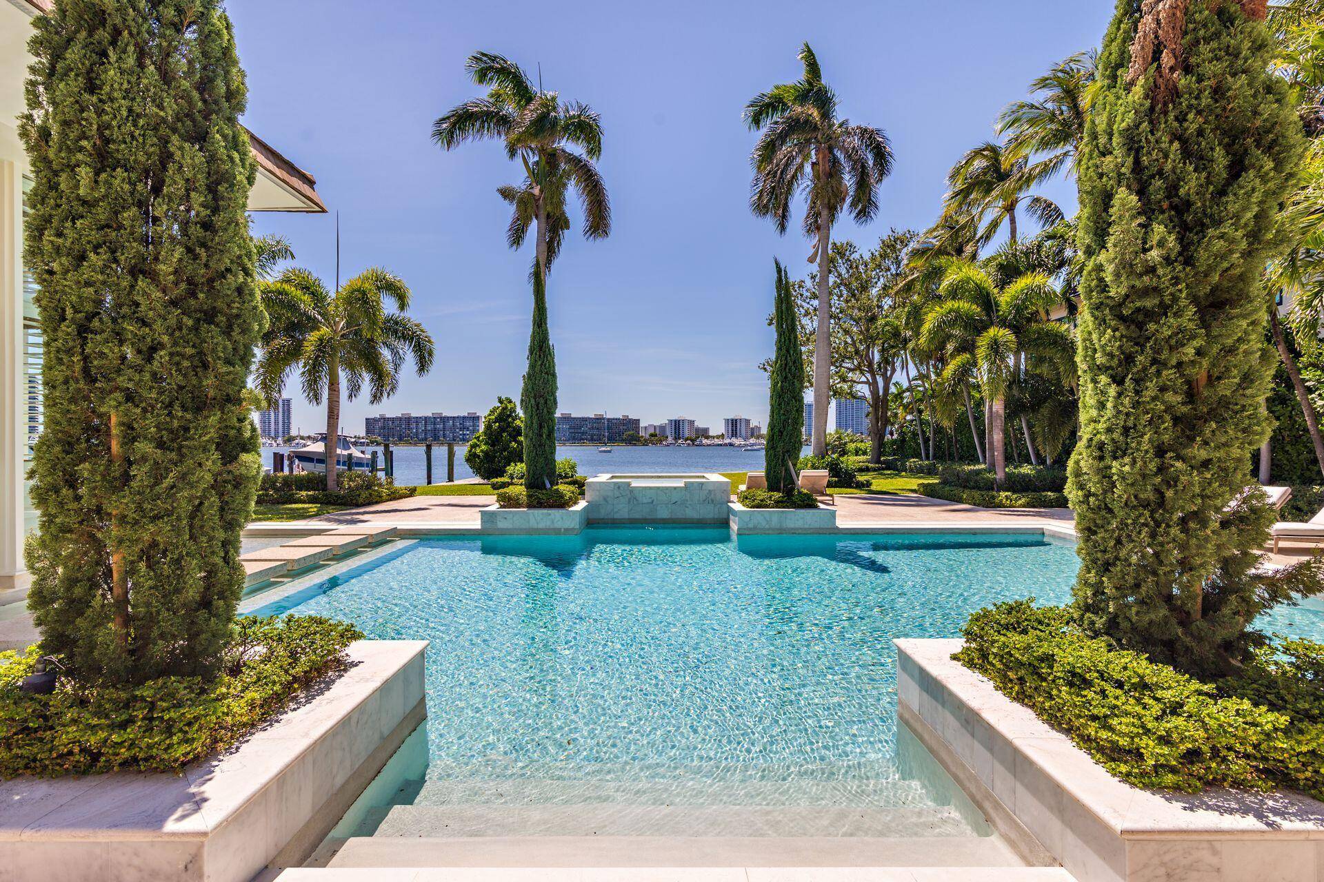Formal gardens on a curved tree lined drive lead up to the gracious entry of this magnificent contemporary style Frank Lloyd Wright style home, which offers the finest in luxury ...