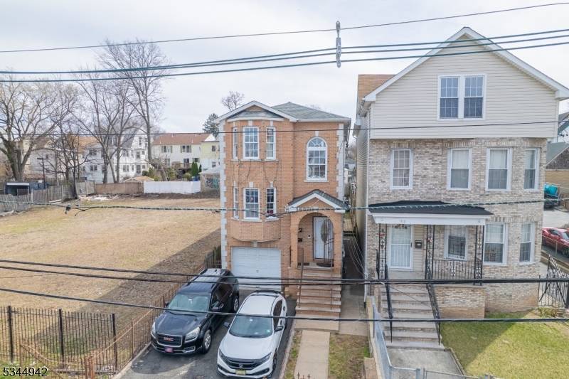 Welcome 2 family house built 2007 with 8 bedrooms, 5 full baths, laundry hookup each unit, garage.