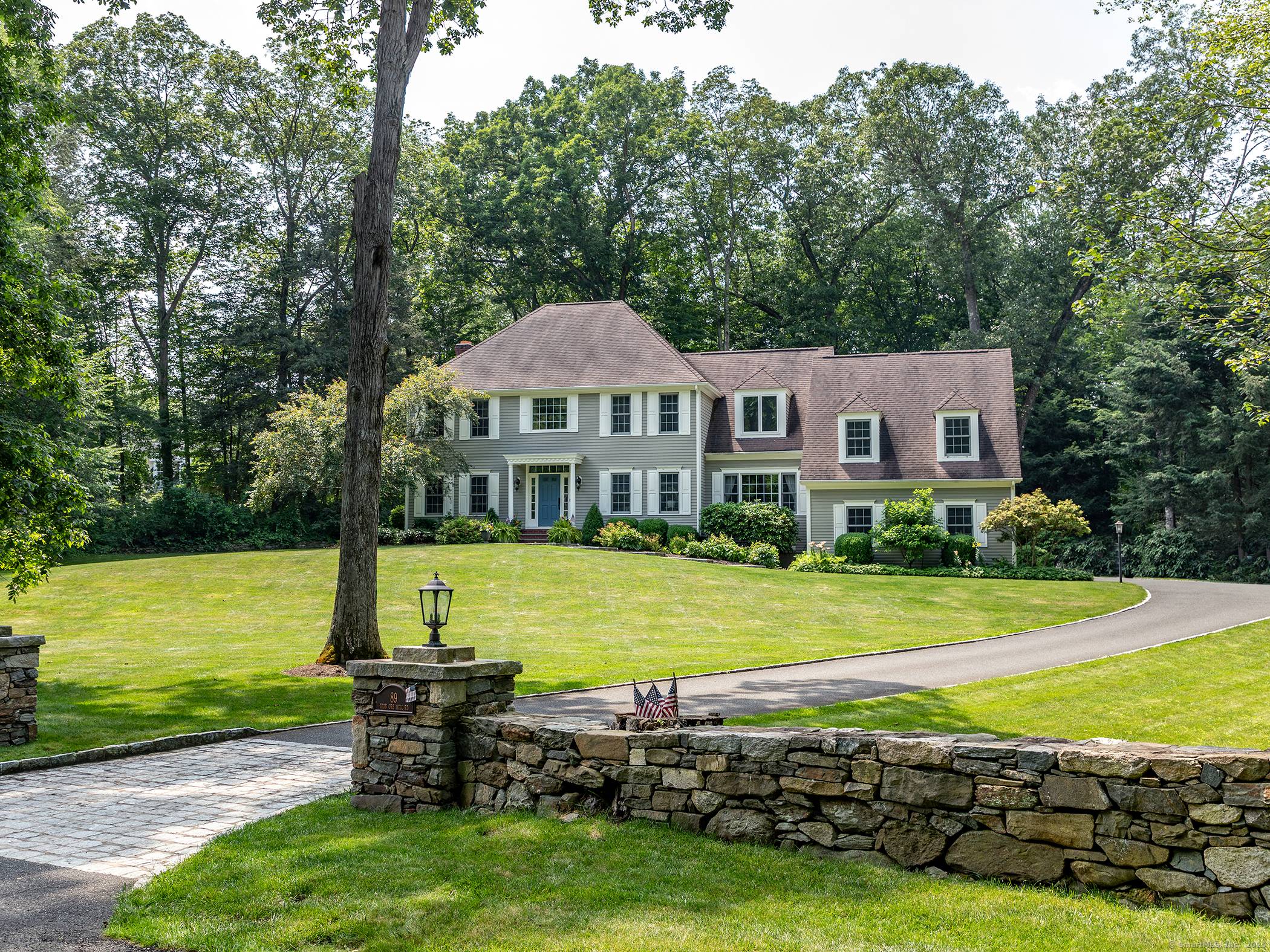 This spacious Colonial is perfectly set on 2 acres adjacent to a nature preserve with hiking trails.