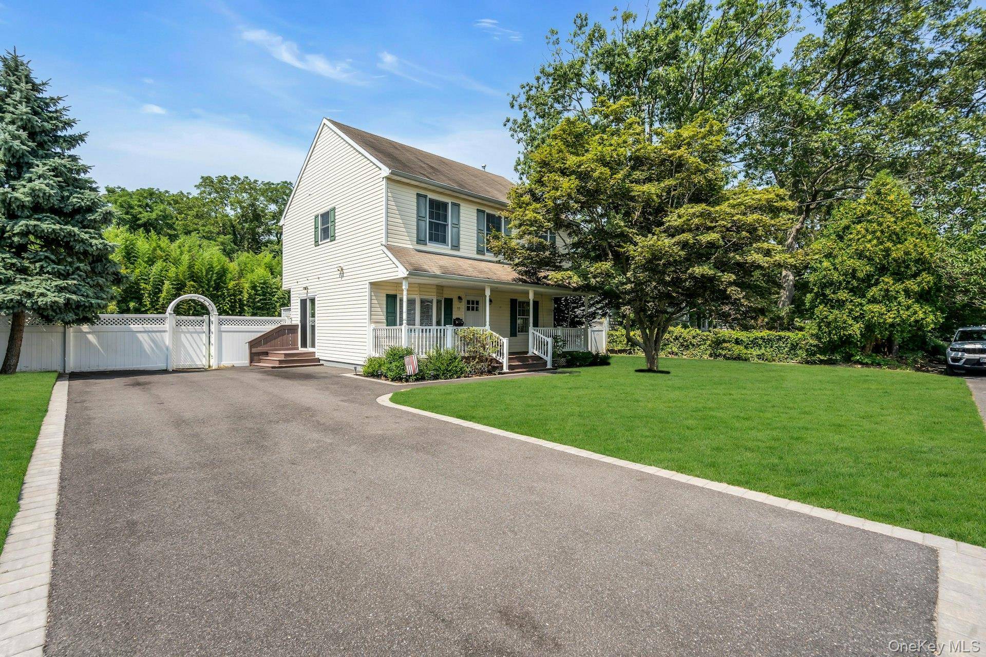 Welcome to this charming Colonial in the heart of desirable South Blue Point, set on a generous property with abundant green space.