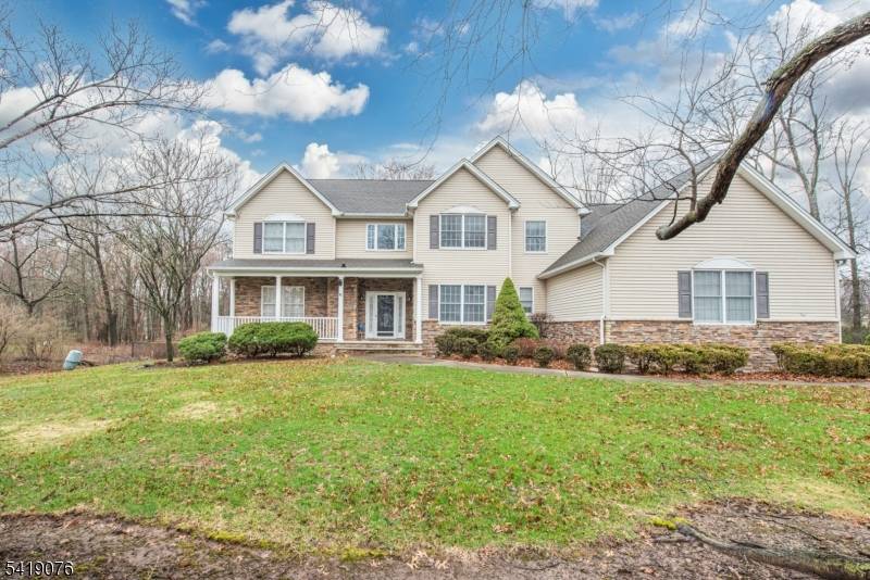 Impressive 5 bedroom, 2. 5 bath Colonial with a welcoming front porch, 3 car attached garage, and beautifully landscaped property.