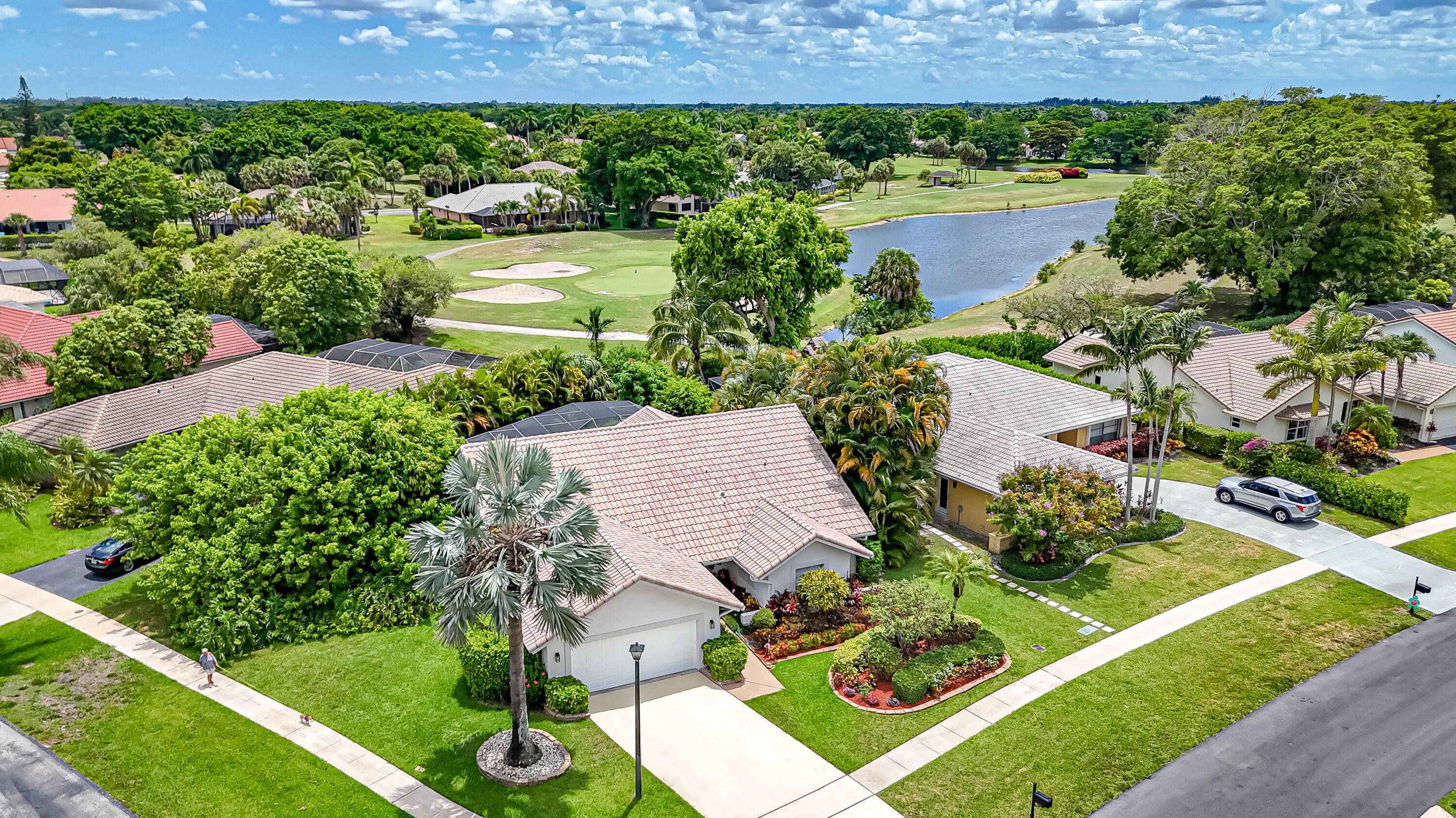 PARADISE ! Gorgeous Pool Home Large Corner Lot Backing Up to Golf Course and Lake No Rear Neighbors Highly Desirable Boca Greens A Rated School District Low HOA Bright Open ...