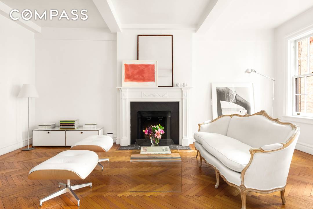Welcome home to this sunny, spacious Upper East Side South facing 2 bedroom, 2 bathroom apartment with a rare working wood burning fireplace.