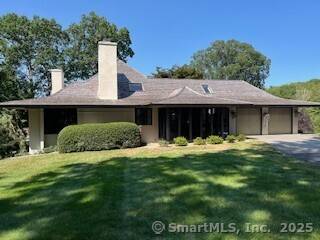 This custom Frank Lloyd Wright inspired home embodies a refined architectural vision defined by balanced proportions, strong clean lines, soaring ceilings, plaster walls, beveled glass windows and meticulous attention to ...